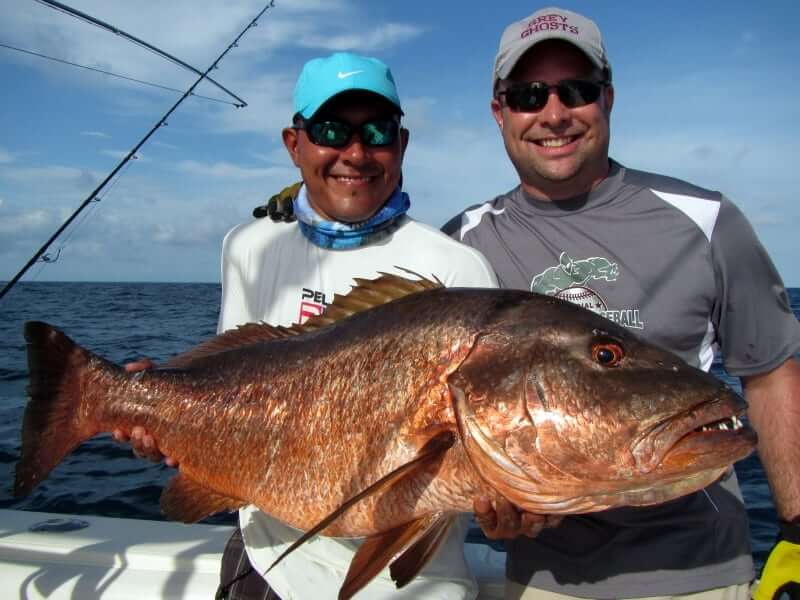 Capt. Juan and angle holding cubera snapper aboard the T.O.P. CAT