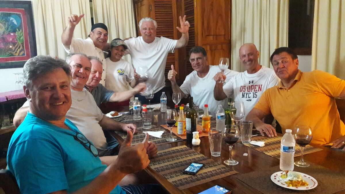 Group of anglers around table enjoying food and beverage