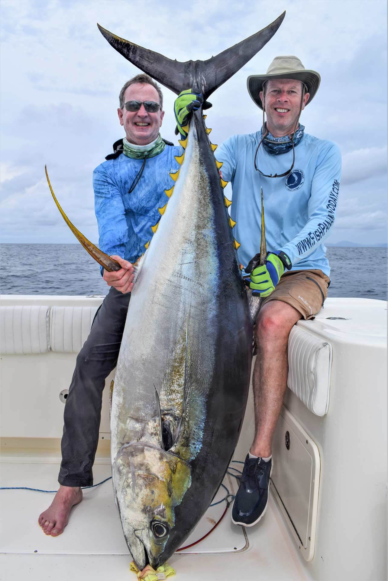 Two smiling angler holding huge yellowfin tuna-fishing in Panama aboard the T.O.P. CAT