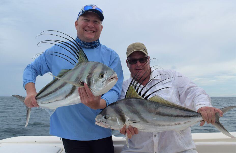 Two smiling anglers posing with roosterfish