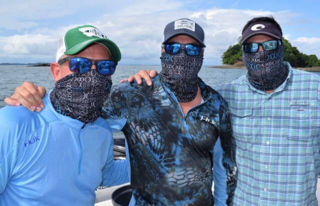 3 masked anglers posing for picture, wearing masks.