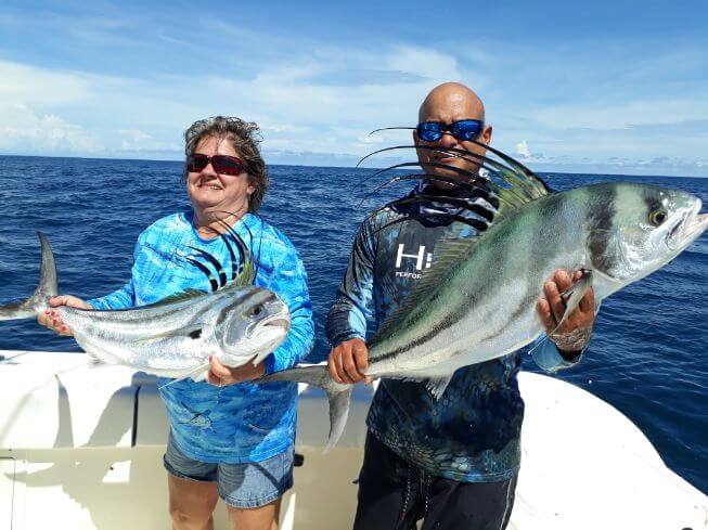Mate and angler posing with roosterfish. Sport Fish Panama Island Lodge