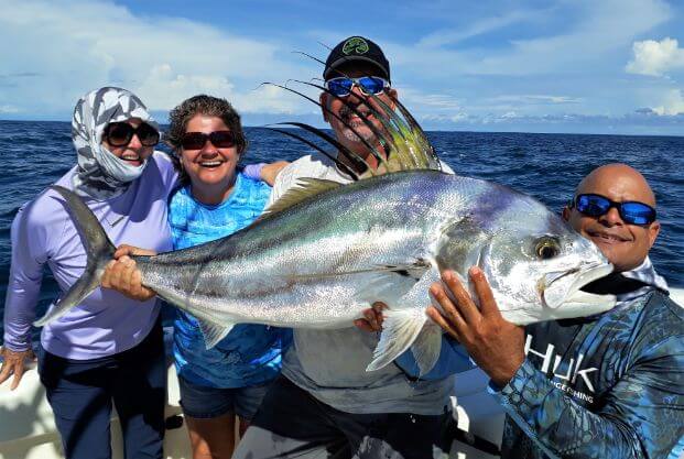 Anglers posing with large roosterfish. 