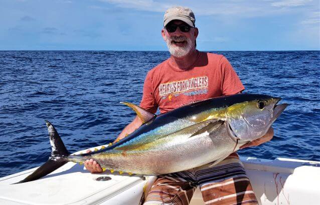Angler posing with Yellowfin tuna