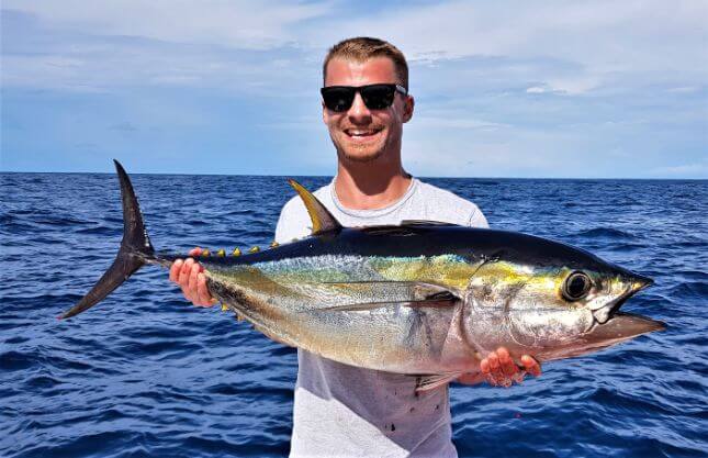 Angler posing with Yellowfin tuna