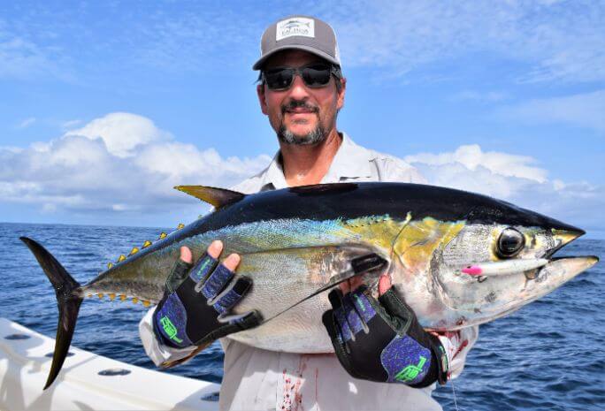 Shady looking angler posing with yellowfin tuna