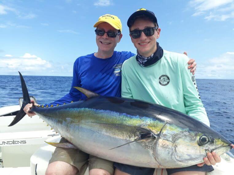 2 anglers posing with yellowfin tuna