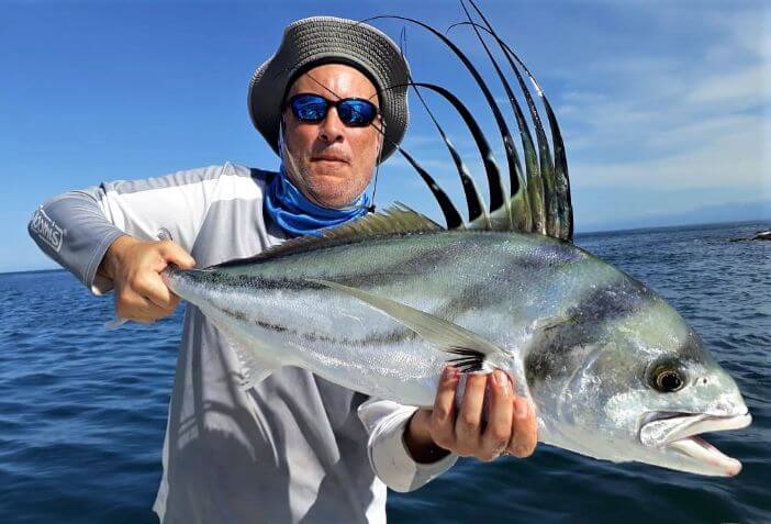 angler posing with roosterfish.  Sport Fish Panama Island Lodge