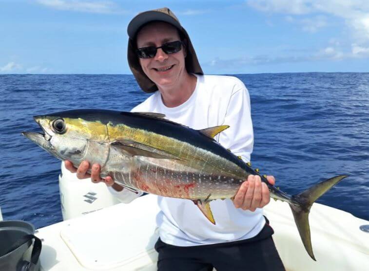 Angler holding a small yellowfin tuna