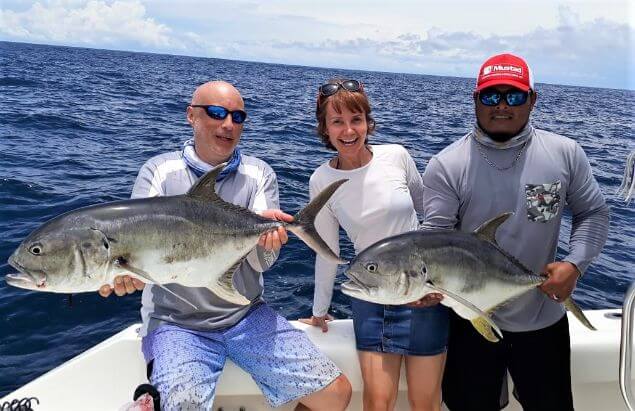 2 anglers and mate posing with  2 Jack Crevalle