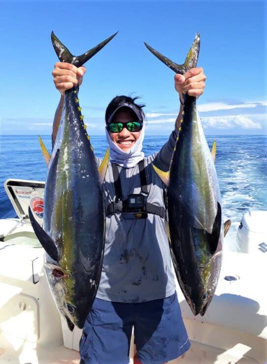 Angler posing witn yellowfin tunas