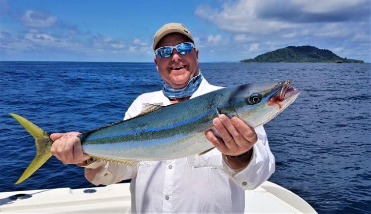 Angler posing with a Rainbow Runner which is another fish in the Jack family that we run across often here in Panama