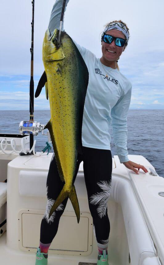 Female angler holding Dorado, also known as ‘Mahi-Mahi’ or ‘Dolphin’ while posing for picture