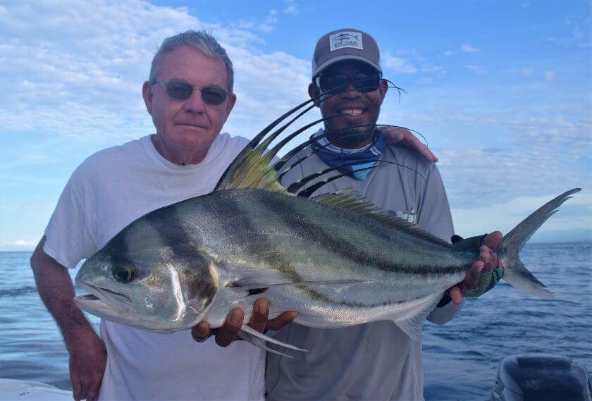 Very good looking man posing with roosterfish and mate. Sport Fish Panama Island Lodge