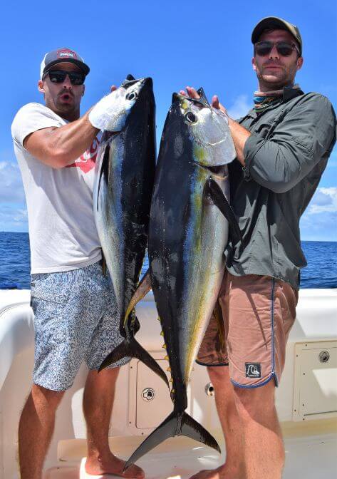 Two anglers posing with 2 yellowfin tuna