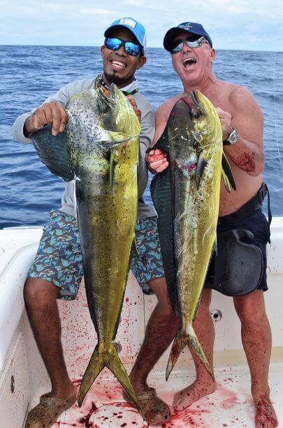 Angler and Mate laughing while posing with dorado.