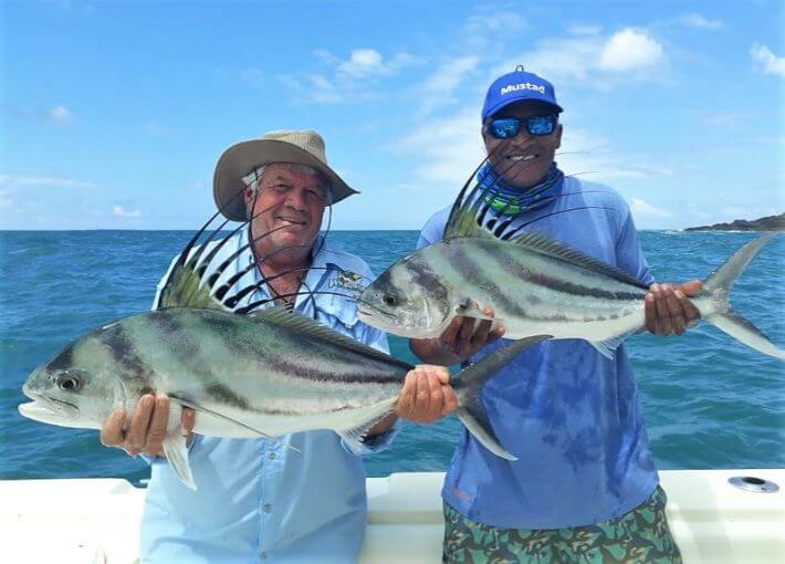 Angler and Mate posing with two small roosterfish