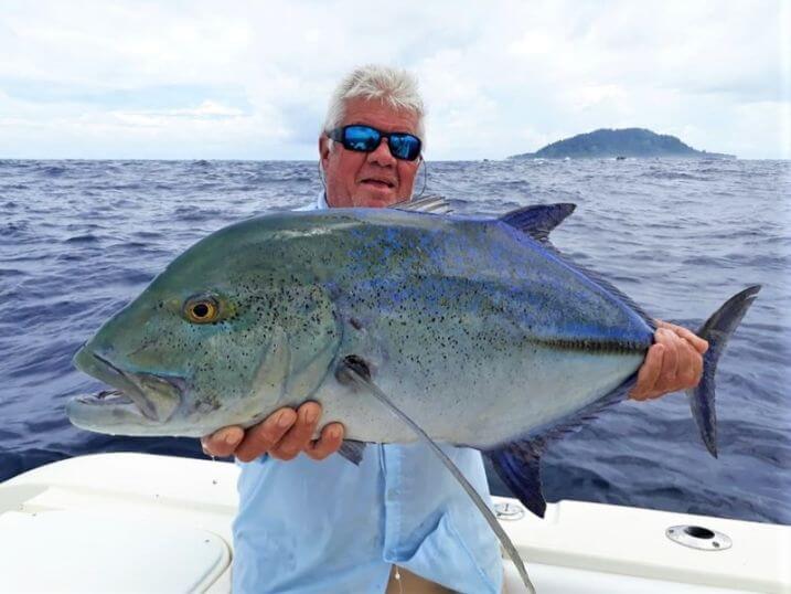 Angler posing with Bluefin Trevally.  Isla Montuosa, Panama in background.
