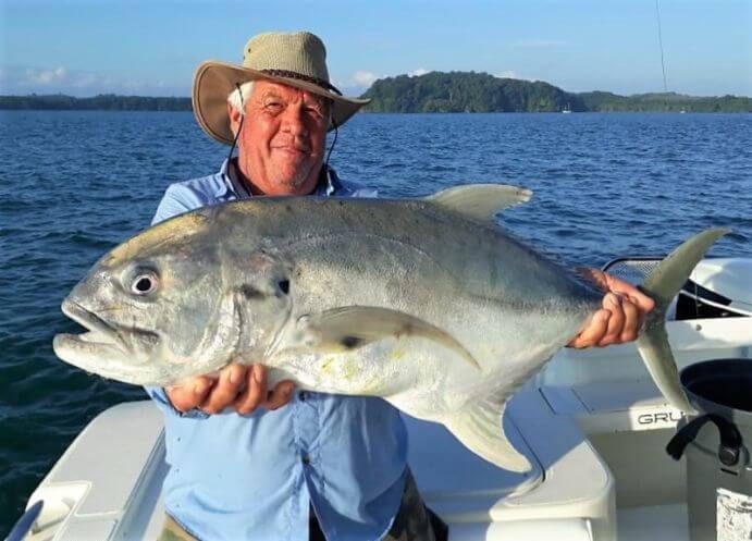 Angler holding large Jack Crevalle while fishing at Sport Fish Panama Island Lodge