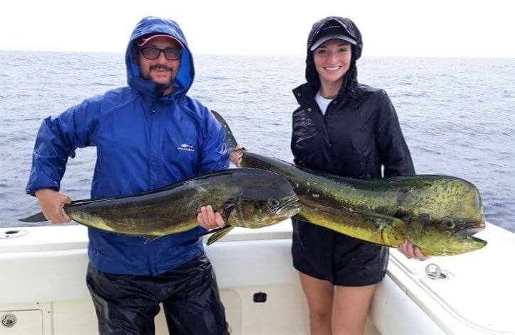 Father daughter fishing team posing with Dorado, also known as ‘Mahi-Mahi’ or ‘Dolphin’ 