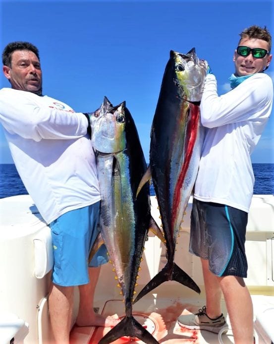 2 angler holding 2 yellowfin tuna for photo op