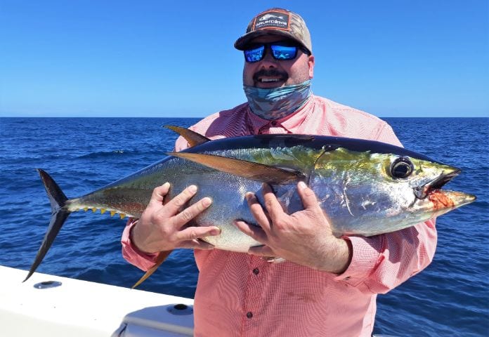 Angler holding 30 pound yellowfin tuna for photo op