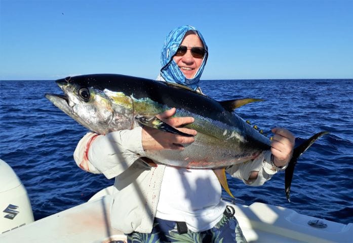 Angler holding 40pound yellowfin tuna 