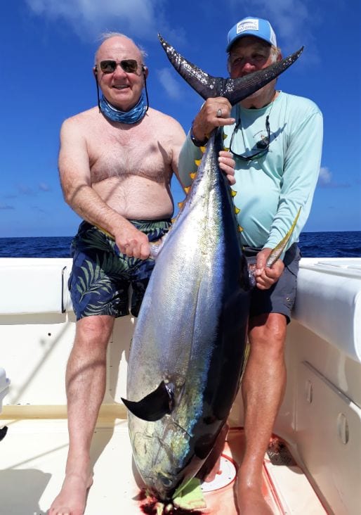 Two anglers holding large Yellowfin Tuna for photo op