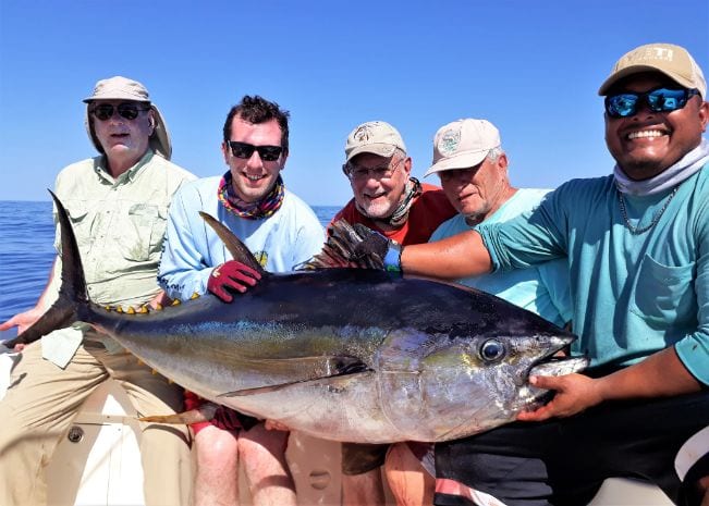 Mate and 4 anglers holding 80 pound yellowfin tuna