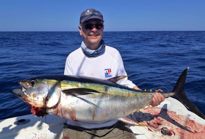 Smiling angler from our Panama fishing lodge holding 50 pound Yellowfin tuna[