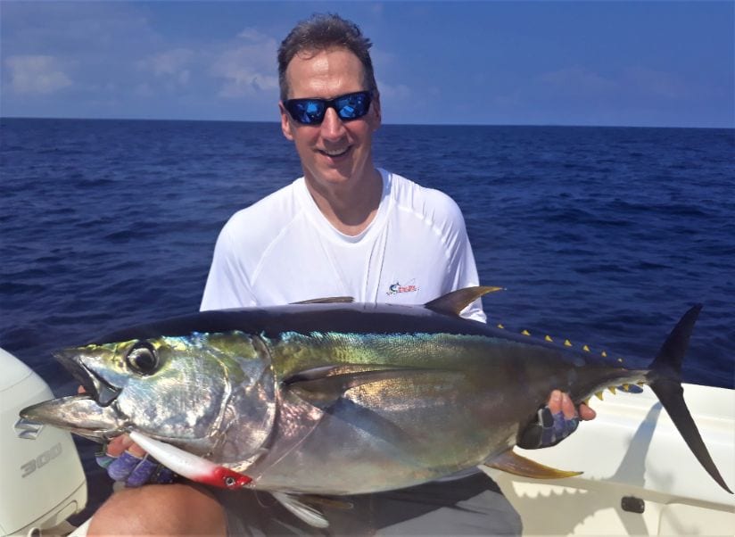 Smiling angler holding 40 pound Yellowfin tuna