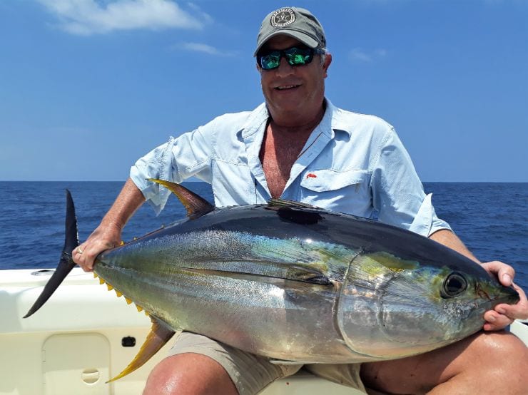 Smiling angler holding 50 pound Yellowfin tuna