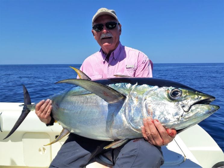 Good looking older gent posing with yellowfin tuna