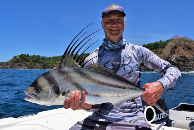 Angler posing with small roosterfish