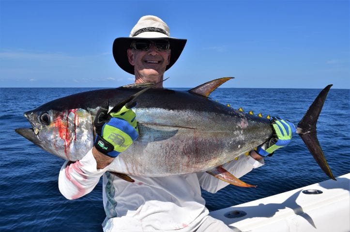 angler posing with yellowfin tuna