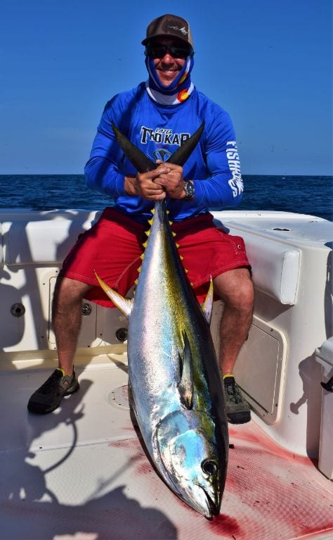 Angler posing with yellowfin tuna