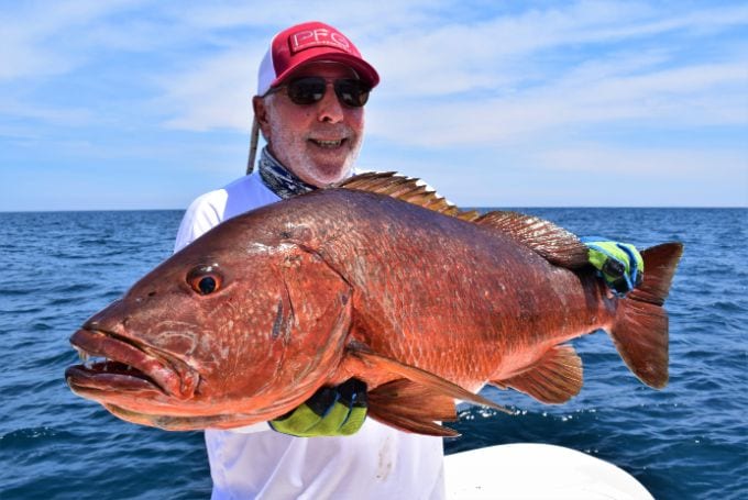 Angler posing with cubera snapper