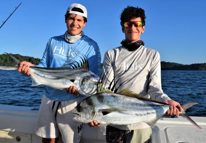 Two junior anglers posing with roosterfish.