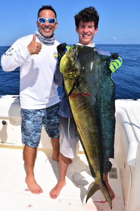 Father and son posing with Dorado, also known as ‘Mahi-Mahi’ or ‘Dolphin’ .