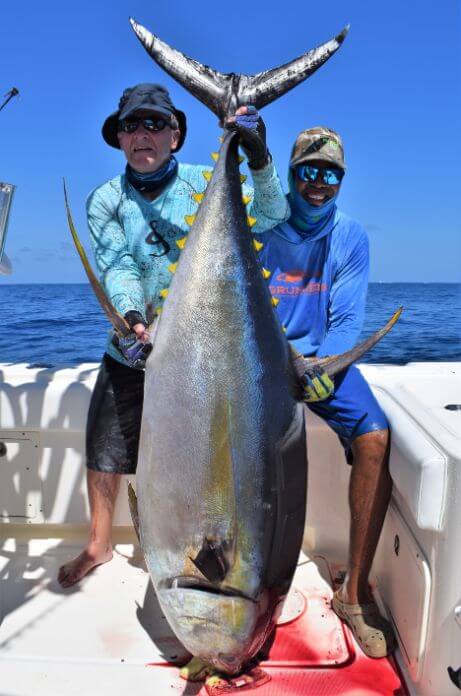 Angler and mate posing with 200 lb plus yellowfin tuna.