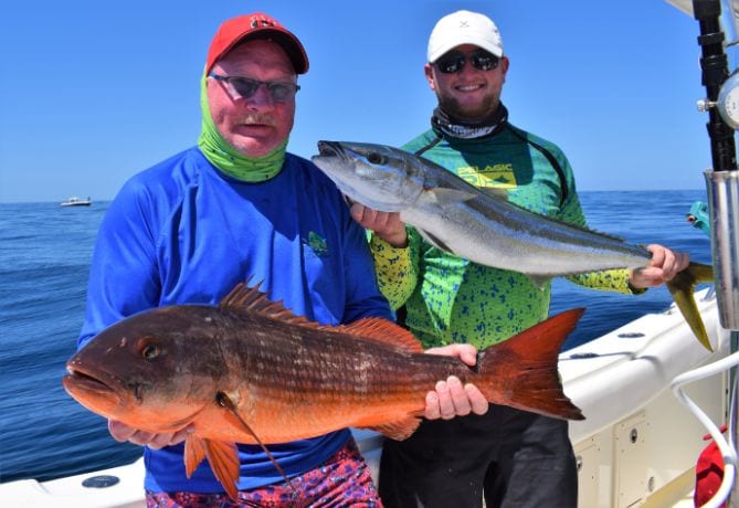 Anglers posing with rainbow runner and mutton snapper