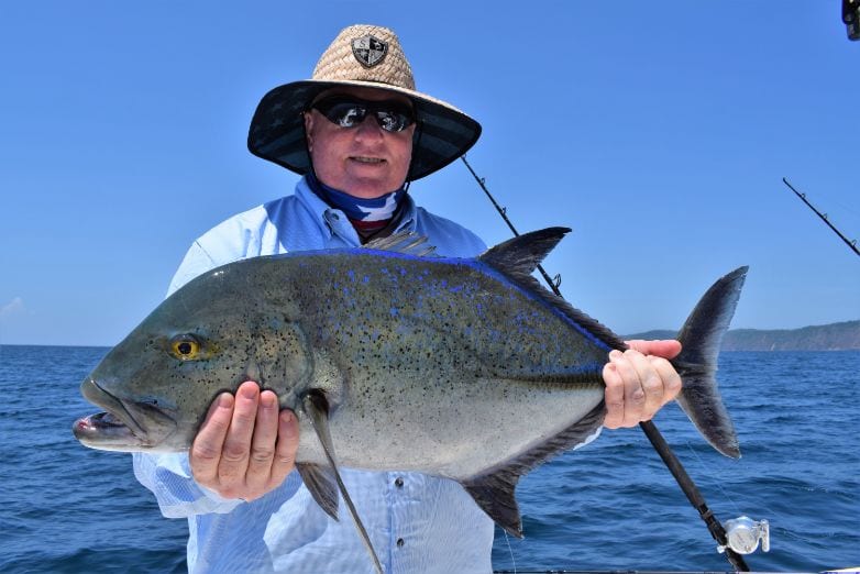 Angler with big hat posing for picture holding Bluefin Trevalle