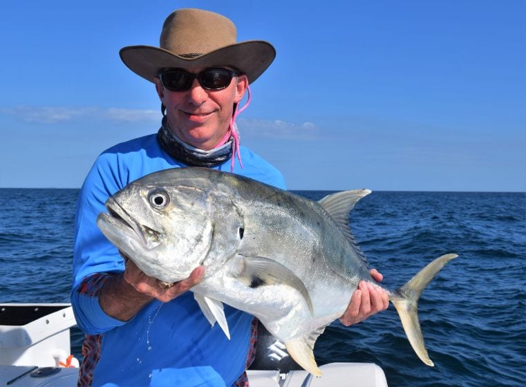 Angler posing for picture holding Almaco jack