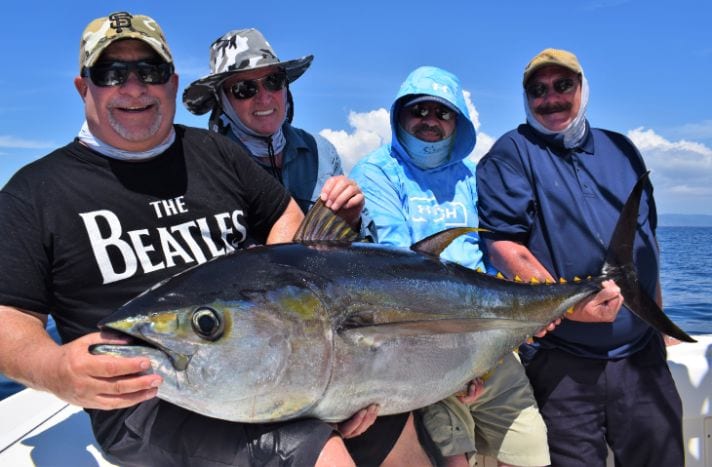 4 anglers posing with yellowfin tuna