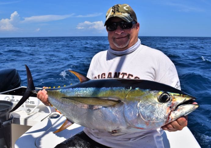 Angler posing with a small yellowfin tuna