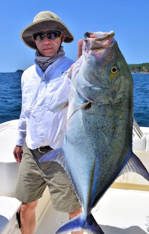 angler holding Bluefin Trevally for photo