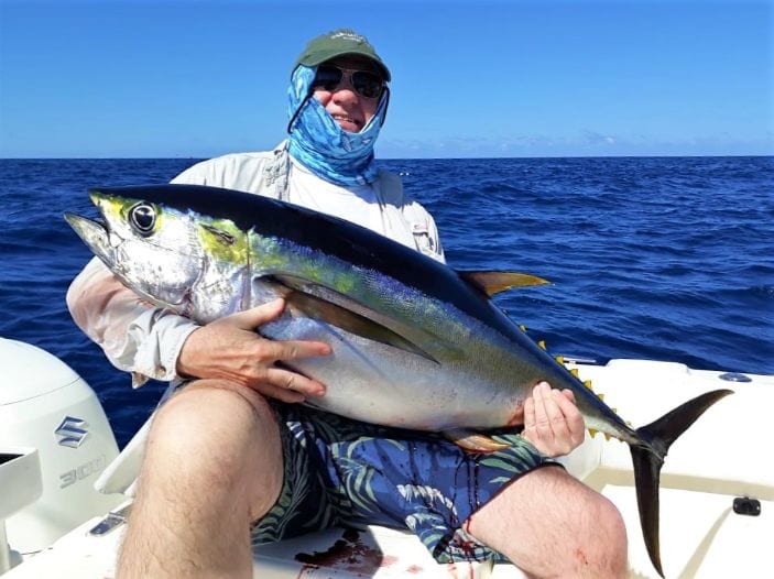 Angler holding 60 pound yellowfin tuna 