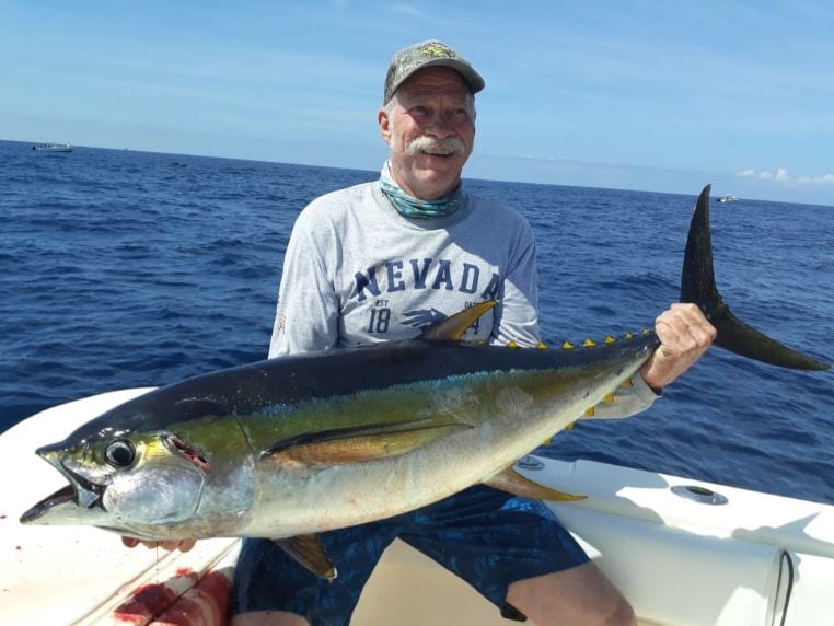 Smiling angler holding 40 pound Yellowfin tuna