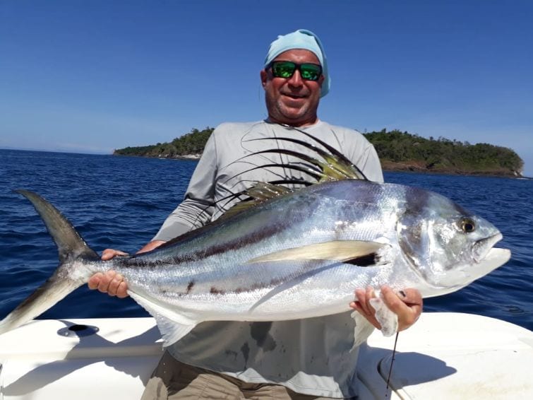 Angler holding large roosterfish for picture