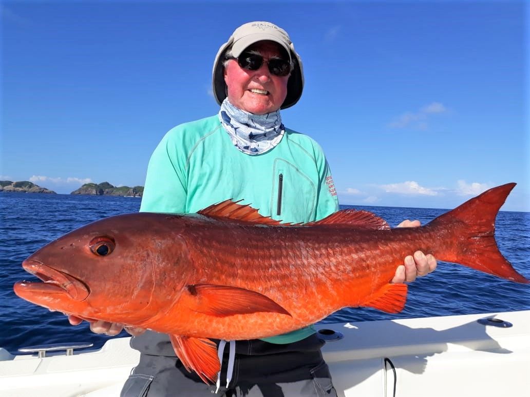 angler posing with mullet snapper